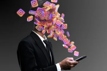 Man in a suit absorbed by a burst of Instagram logos streaming from his smartphone, symbolizing the impact of social media.