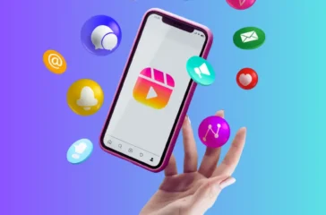 Hand tossing a smartphone with colorful social media and communication icons floating above it on a blue-purple gradient background.