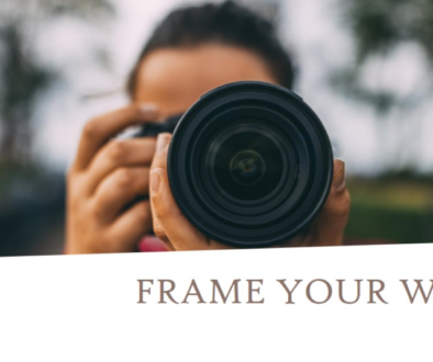 Close-up of a camera held by a photographer, emphasizing the phrase "Frame Your World" and inviting a fresh perspective. photo